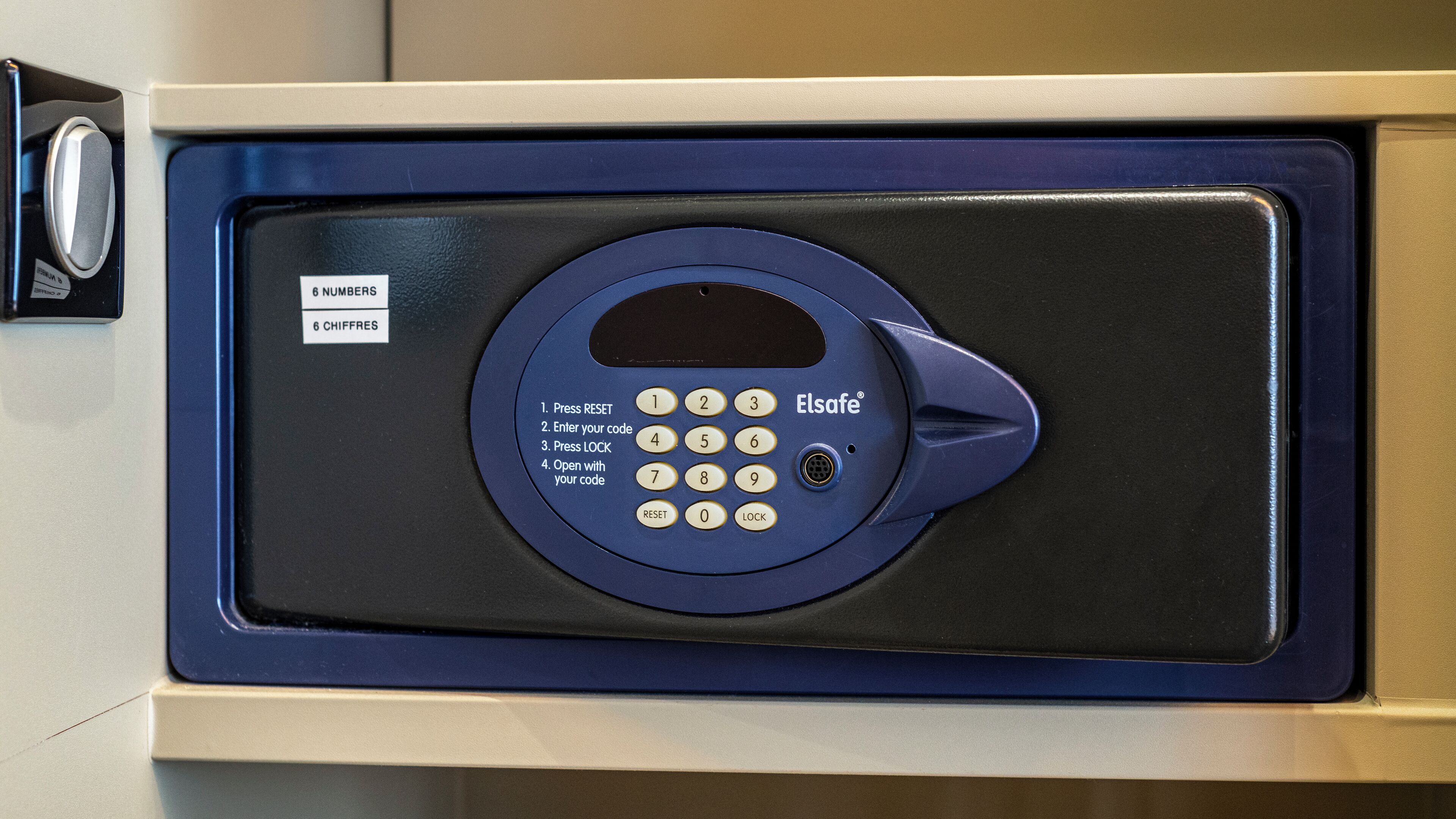 A blue and black security keypad with instructions for use.