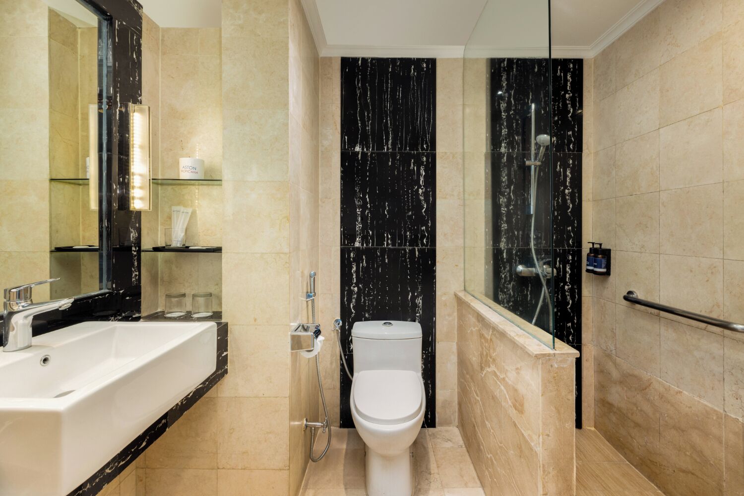 A modern bathroom with a bathtub, toilet, and shower area.