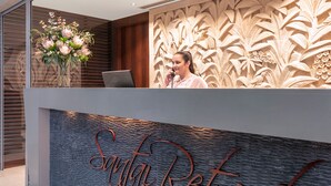 A reception desk with a carved floral design and the words "Sundance Retreat" on the wall.