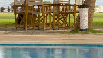 Outdoor pool, open 6 AM to 8 PM, free cabanas, pool umbrellas