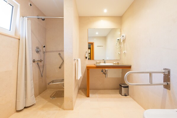 A modern bathroom with a shower, toilet, and sink.