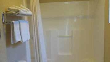 A bathroom with a toilet, a bathtub, and a shower curtain.