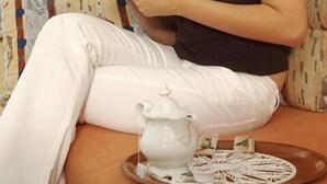 A person sitting on a sofa with a teapot and cup on a tray. - Landgasthof Haus zur Sonne (Hallenberg)