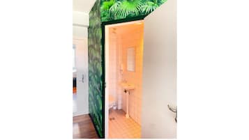 A bathroom with a tiled floor, a sink, and a toilet.