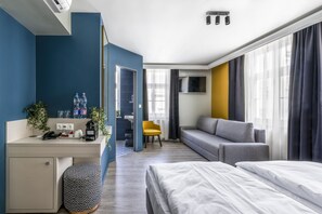 A modern hotel room with a desk, two beds, a sofa, and a TV. - Alta Moda Hotel by Mellow Mood Hotels (Budapest)
