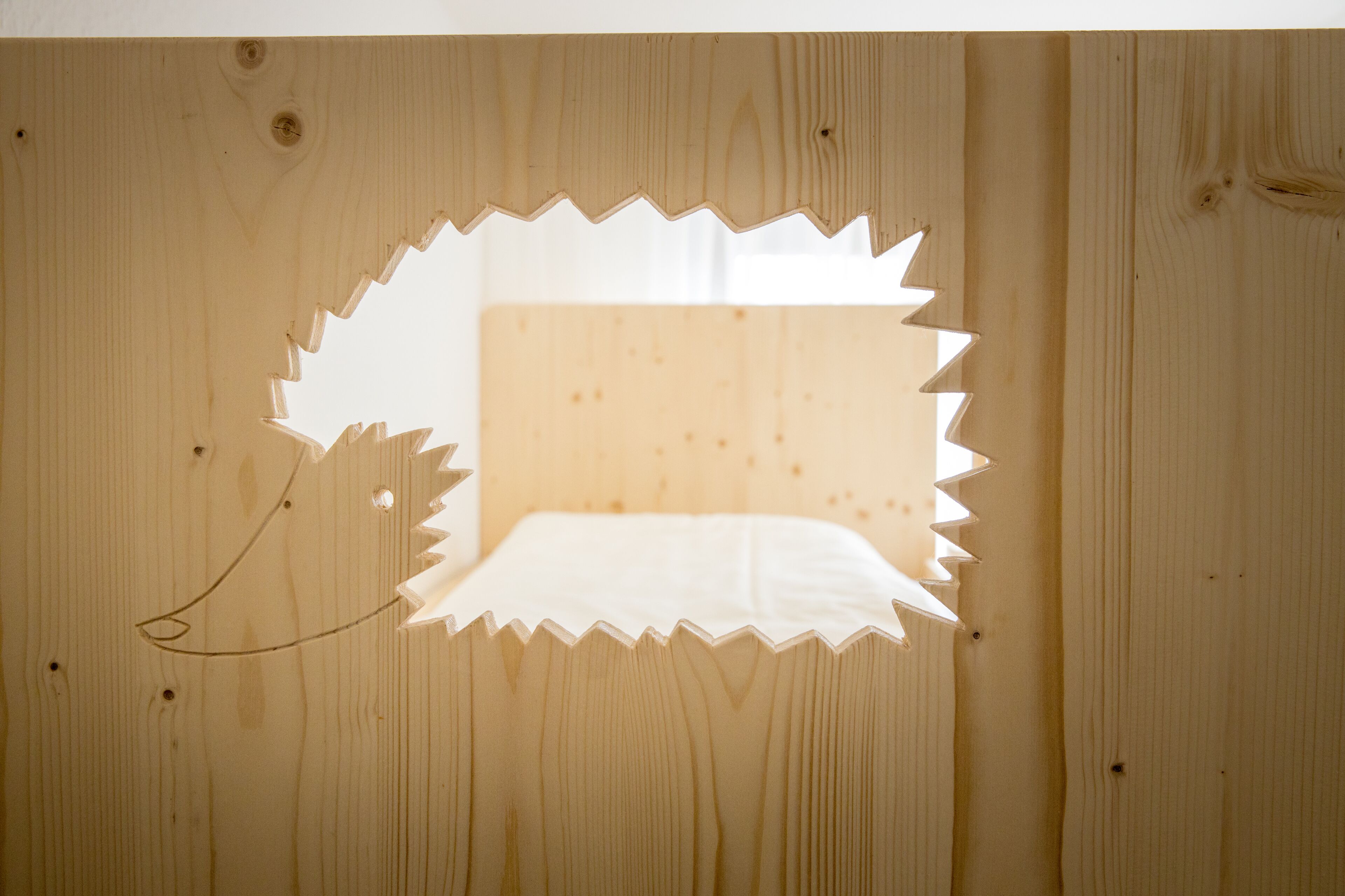 A wooden panel with a cut-out shape, possibly for a window or decorative element.