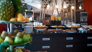 A buffet with various food items and a coffee machine. - Domina Milano Fiera (Novate Milanese)