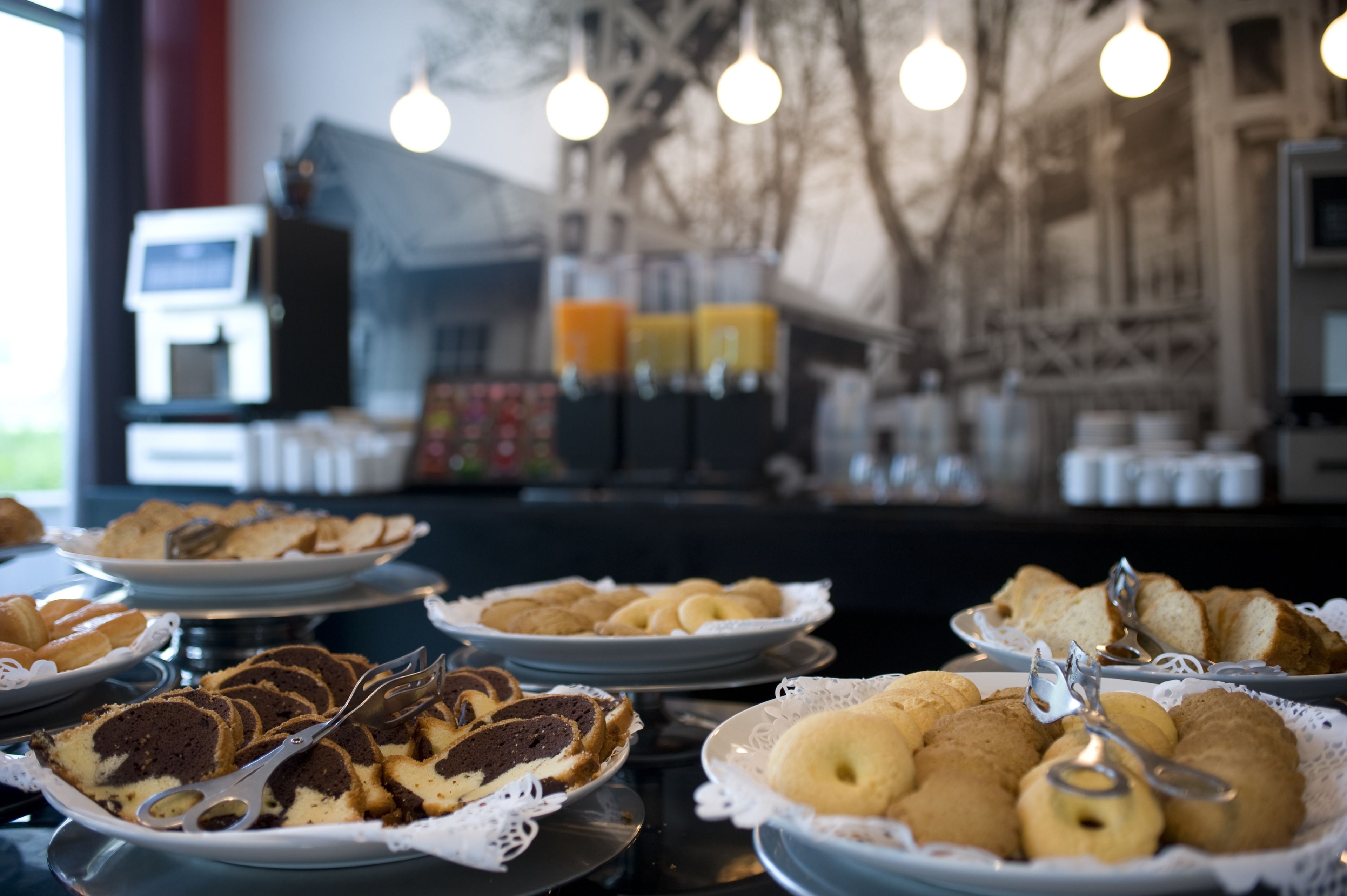 A buffet table with various pastries and bread.