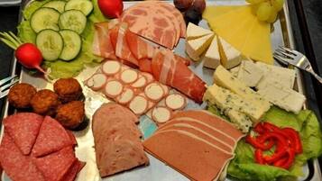 A variety of meats and cheeses on a tray.