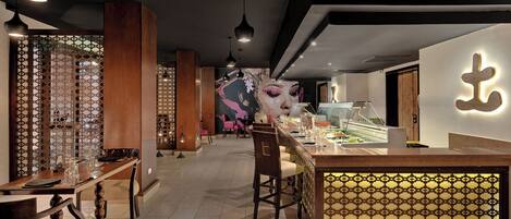 A modern interior with a reception desk, wooden furniture, and patterned decor.