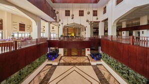 A spacious atrium with a high ceiling, multiple balconies, and a central open area with a patterned floor. - Steigenberger Aqua Magic Hotel (Hurghada)
