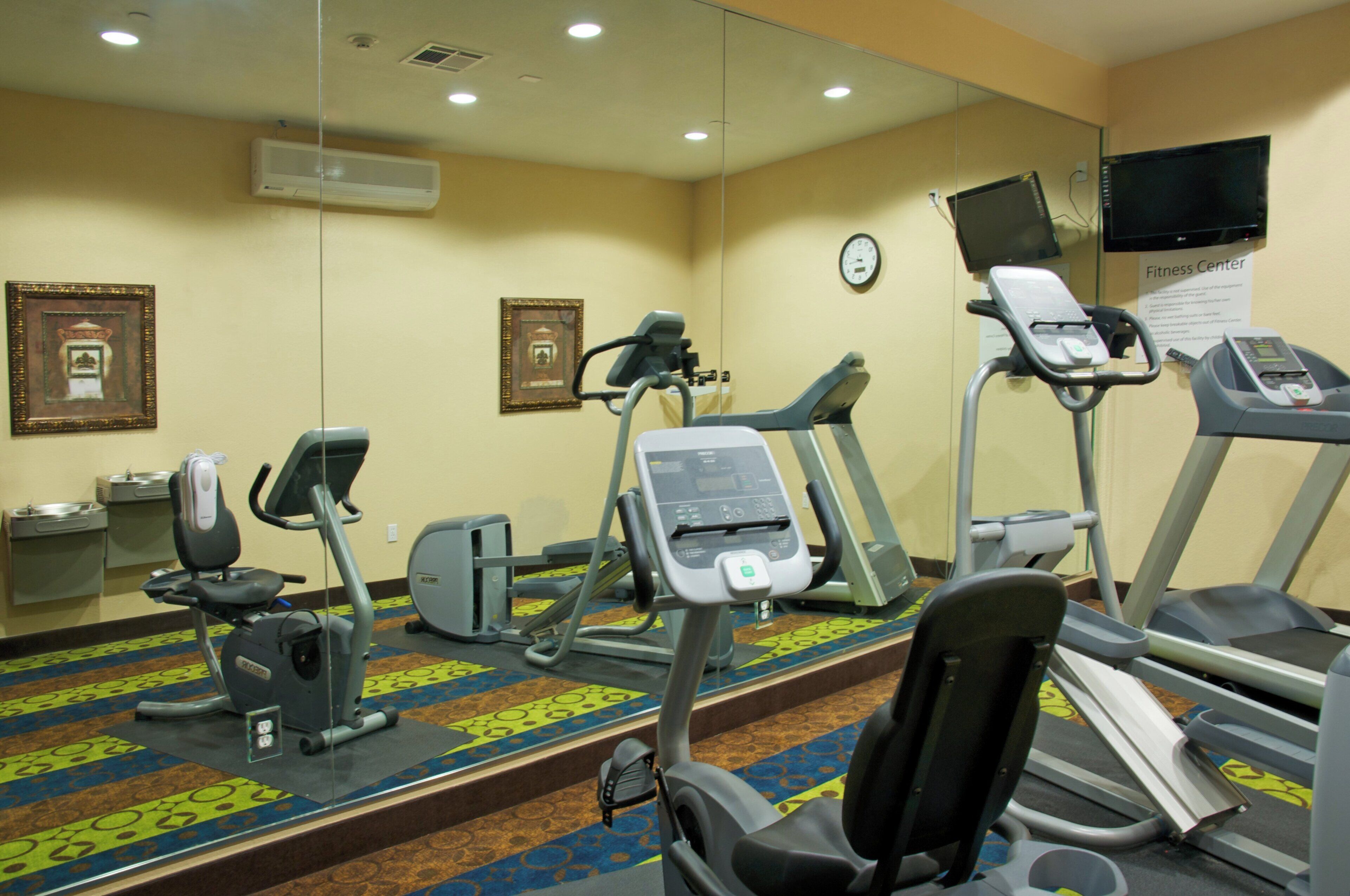A fitness center with treadmills, an elliptical, and a stationary bike.