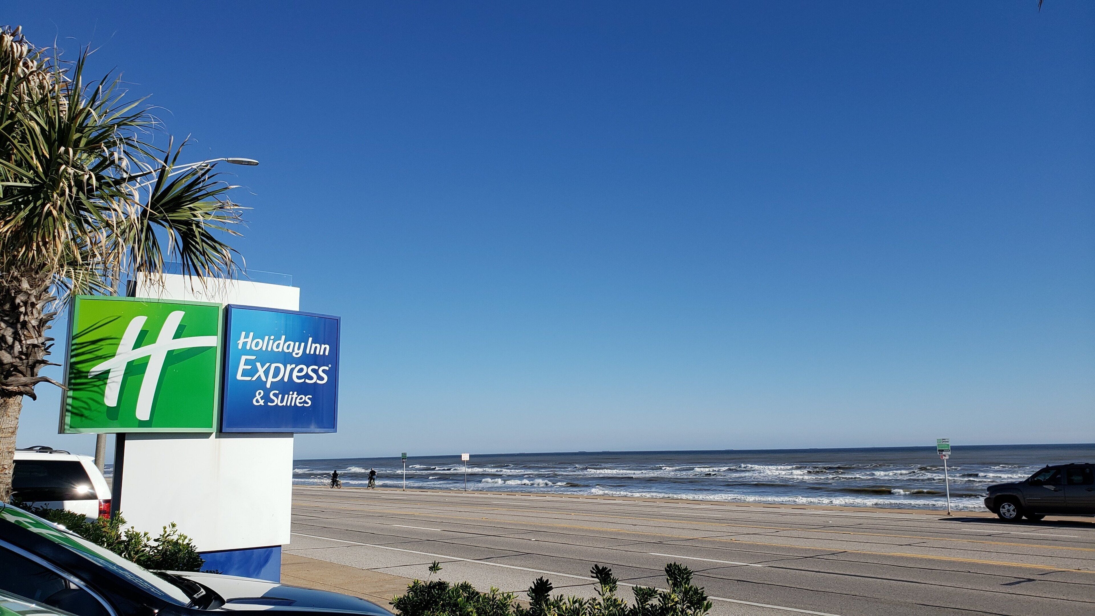 A beachside view with a sign for Holiday Inn Express & Suites.