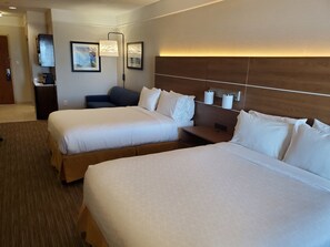 A hotel room with two beds, a desk, a chair, a coffee machine, and framed artwork on the wall. - Holiday Inn Express & Suites Galveston West-Seawall by IHG (Galveston)