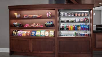 A snack and beverage vending machine with multiple shelves and compartments.