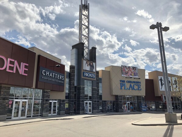 A commercial building with multiple storefronts including 'CHATTERS Hair Beauty Salon' and 'Rick's'.