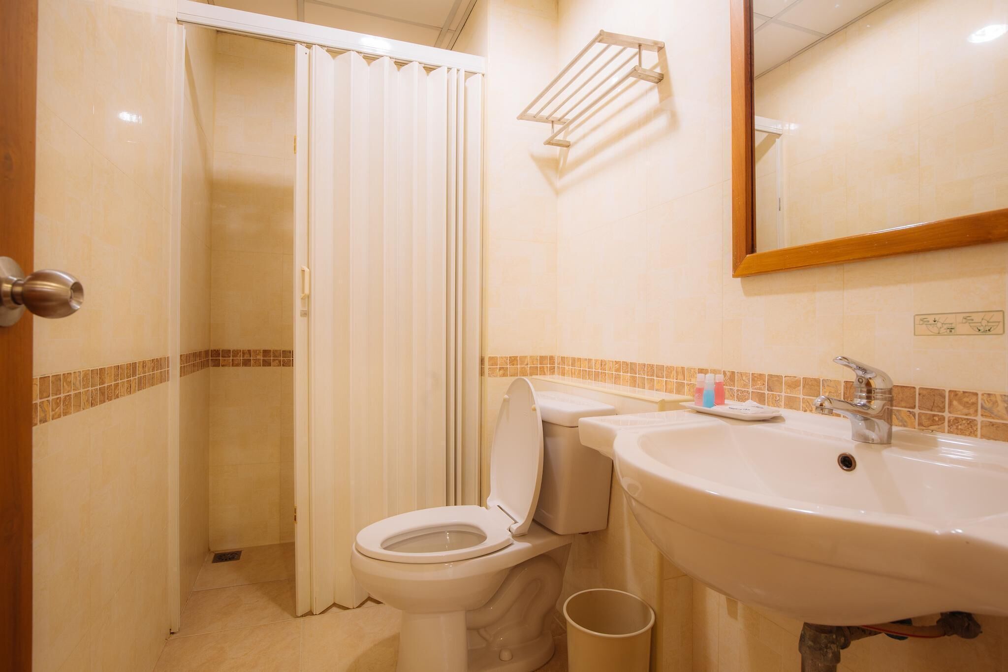 A bathroom with a toilet, sink, and a shower curtain.