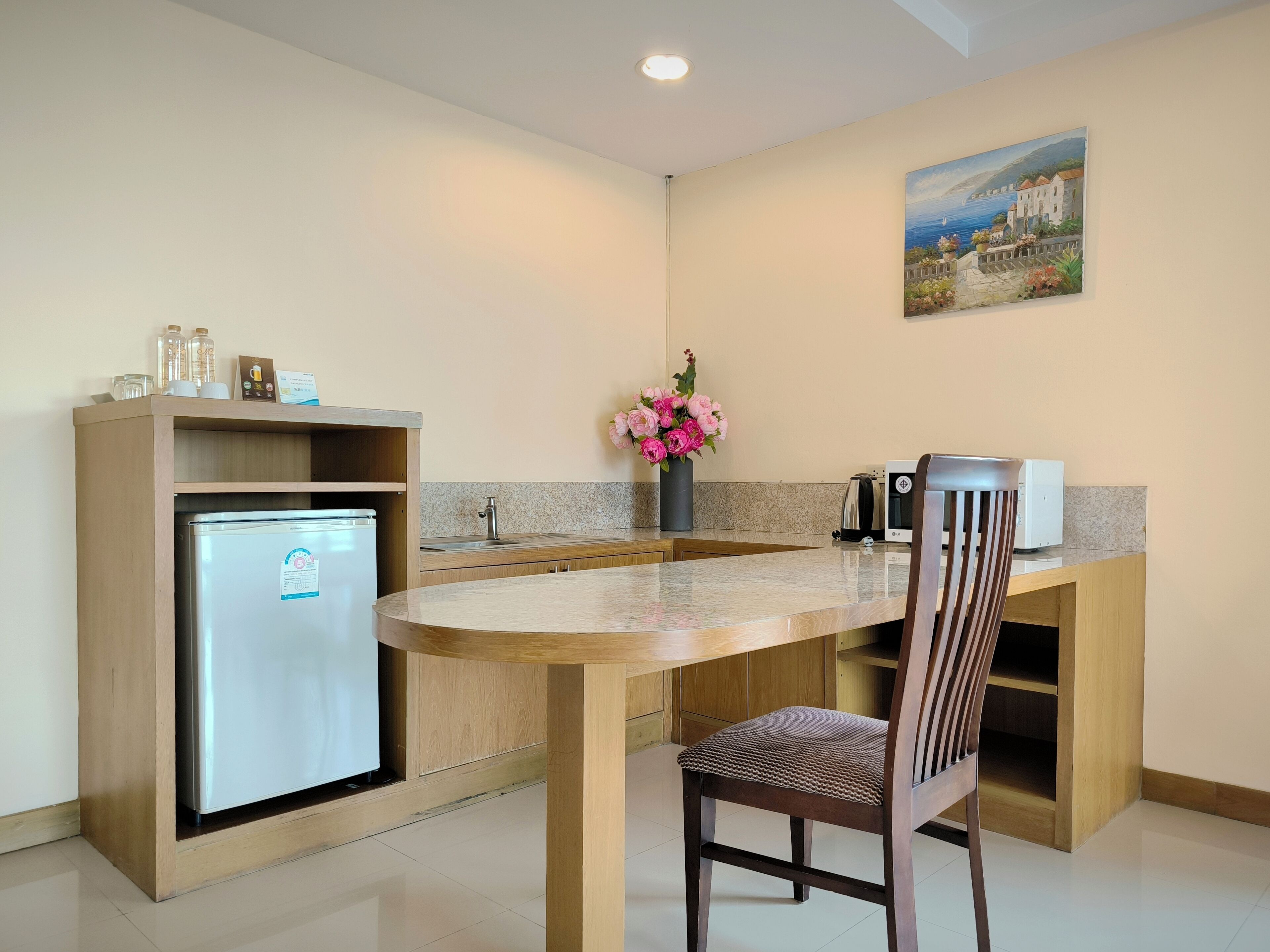 A compact kitchen with a built-in refrigerator, a sink, and a countertop.