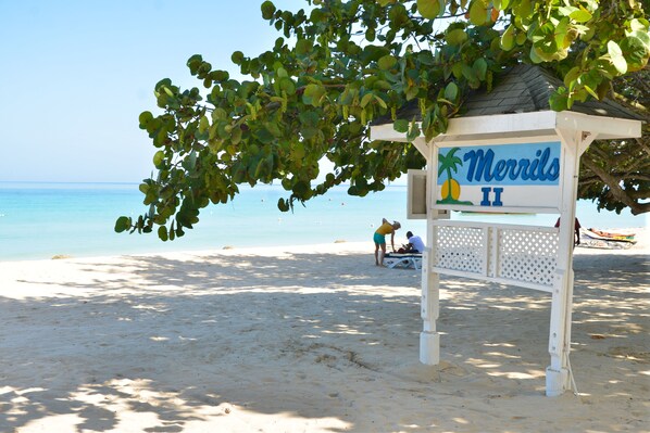A beach sign with 'Merrils II' and a palm tree symbol.