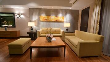 A modern living room with a sofa, a coffee table, and two lamps.