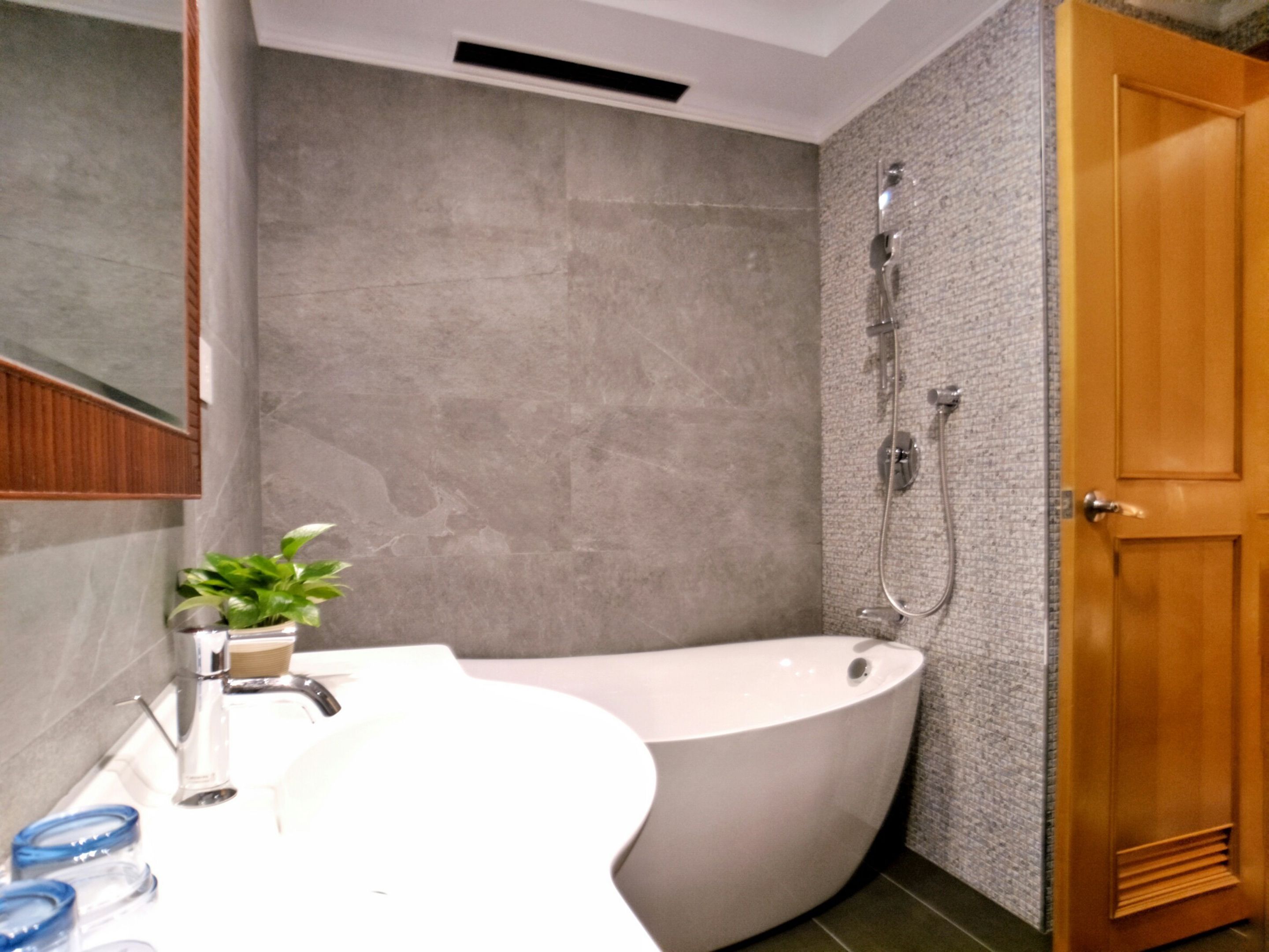 A modern bathroom with a freestanding bathtub, a sink, and a shower.