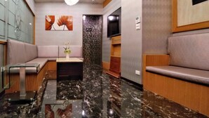 A lobby with marble flooring, seating areas, a chandelier, artwork, and a television. - Taipei Star Beauty Resort Hotel (Taipei)