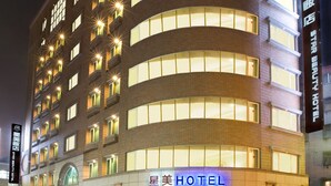 A multi-story hotel with a prominent "HOTEL" sign at the ground level, featuring a modern architectural design with a curved facade and multiple windows. - Taipei Star Beauty Resort Hotel (Taipei)