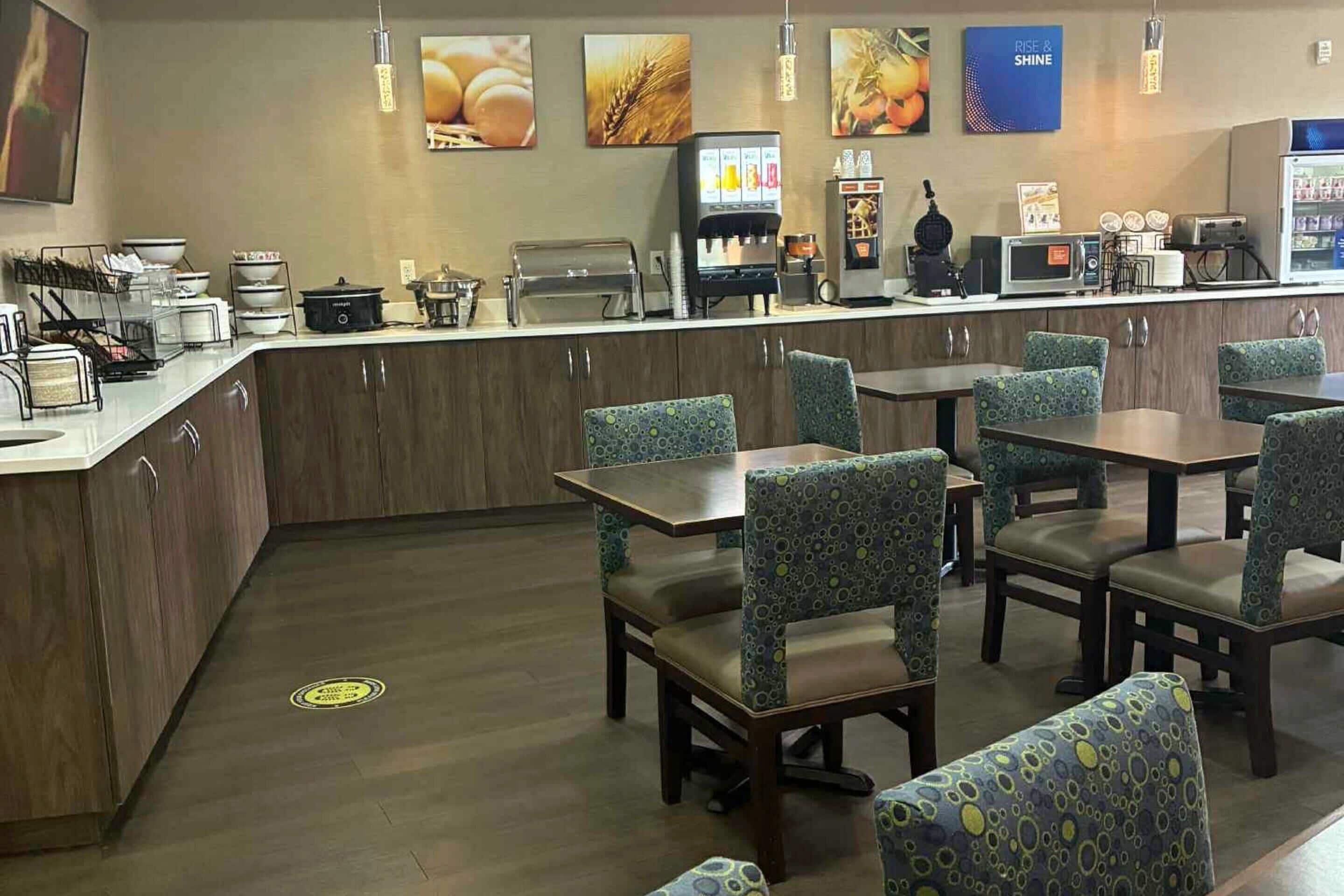 A restaurant with a counter, seating area, and various appliances.