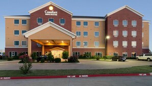 A Comfort Inn & Suites hotel with a central entrance, multiple floors, and a fire lane marked on the pavement. - Comfort Inn & Suites Regional Medical Center (Abilene)