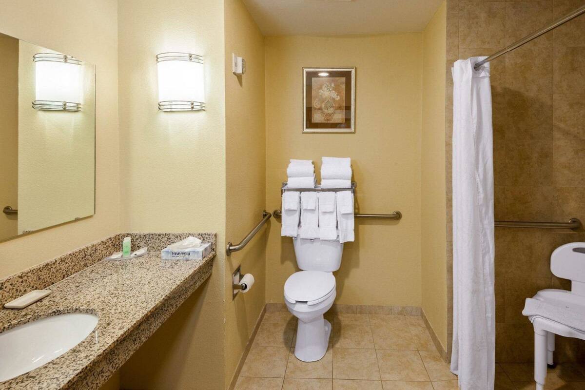 A bathroom with a sink, toilet, and shower.