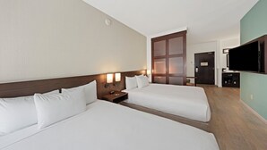 A hotel room with two beds, a TV, a desk, and a wardrobe. - Hyatt Place West Palm Beach/Downtown (West Palm Beach)