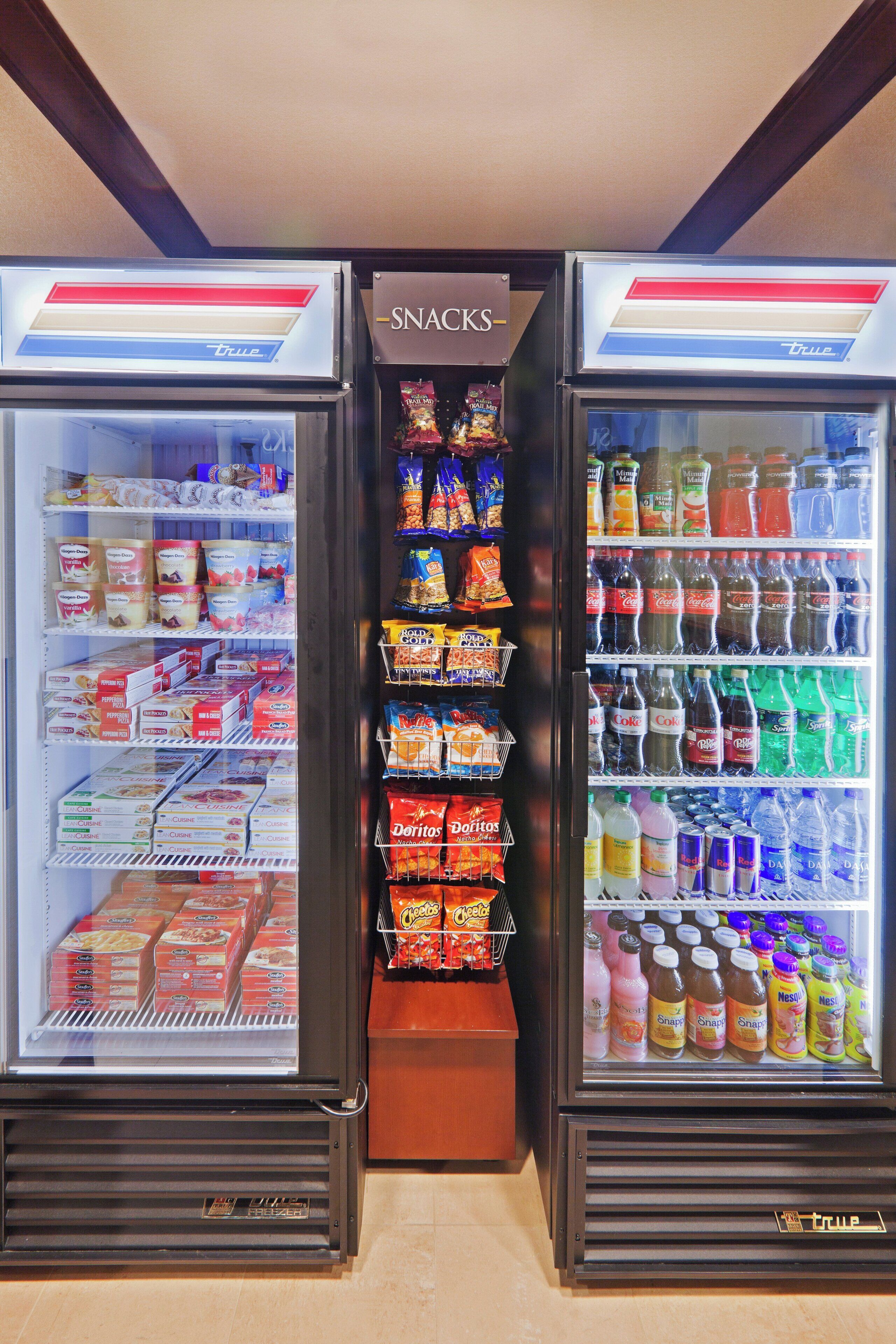 A refrigerated snack display with various packaged snacks and beverages.