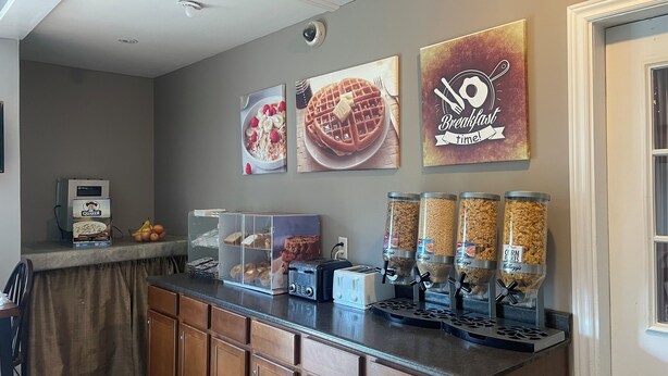 A kitchen with a coffee maker, toaster, and cereal dispensers.