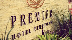A sign for the Premier Hotel in Pinetown with a crown logo and the hotel's name. - Premier Splendid Inn Pinetown (Pinetown)