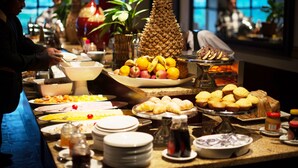 A buffet with various food items, including fruits, pastries, and condiments. - The Edwardian (Port Edward)