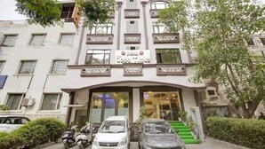 A hotel with a sign reading "Hotel Good Times" and a staircase leading to the entrance. - Good Times (New Delhi)