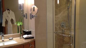 Une salle de bain moderne avec une douche à parois de verre, un meuble-lavabo et un miroir.