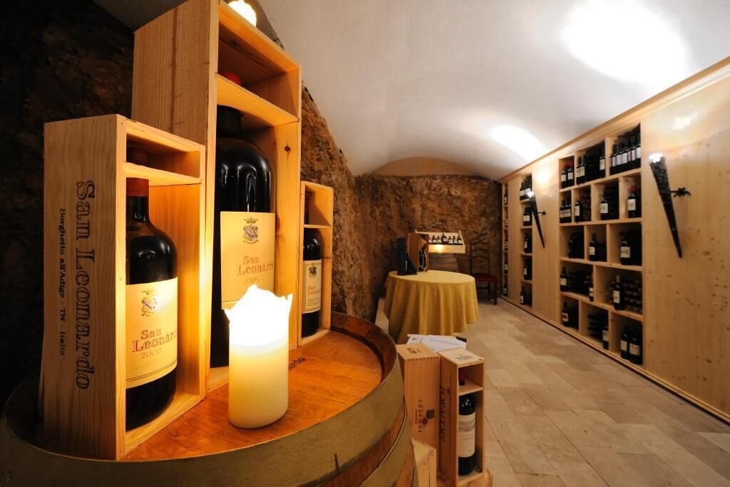 A wine cellar with wooden shelves and a round table.