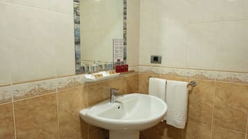 A bathroom with a sink, mirror, and towel rack.