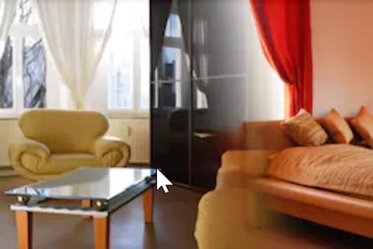 A room with a bed, a chair, and a table.