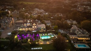 A large hotel with multiple guest rooms, a swimming pool, and a well-maintained garden. - Luccombe Hall Hotel (Shanklin)