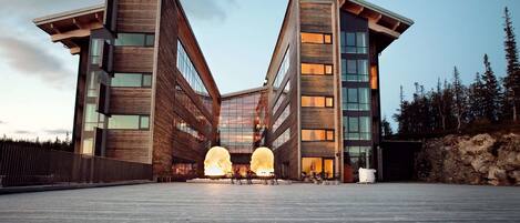A modern building with a wooden facade and large windows.