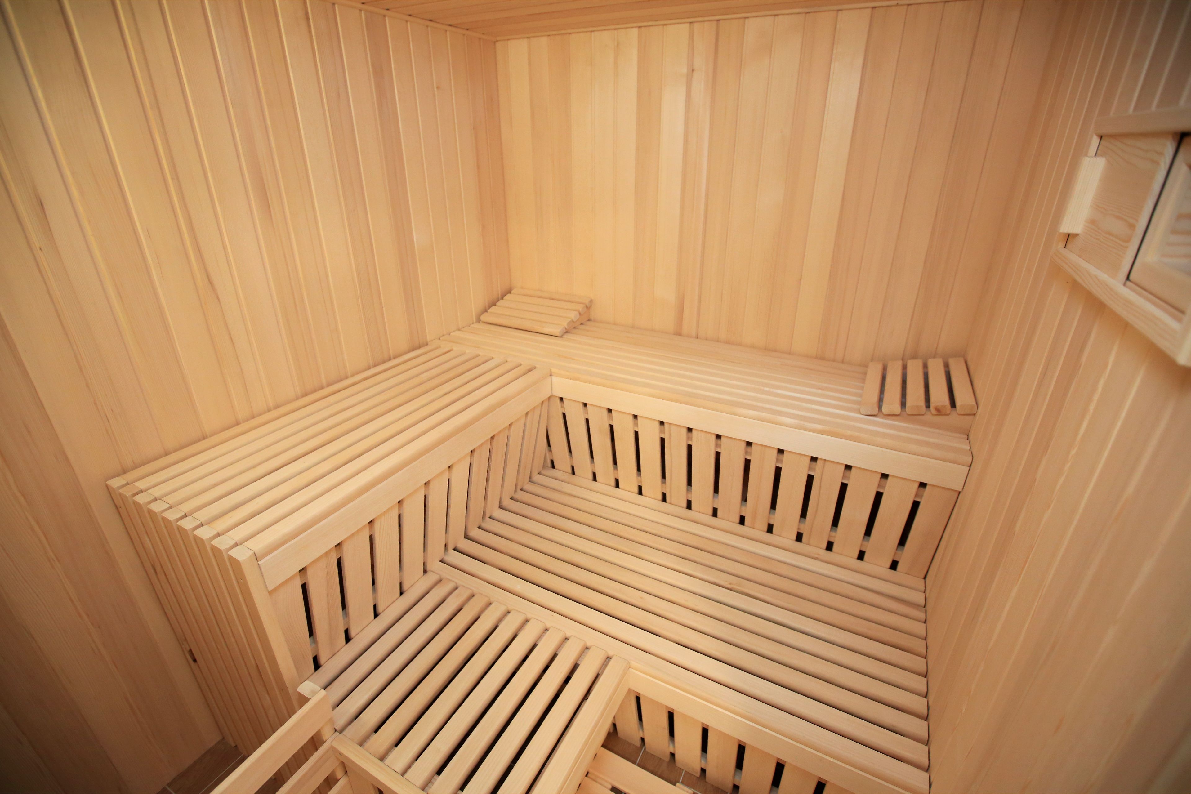 A sauna with wooden benches arranged in a semi-circular pattern.