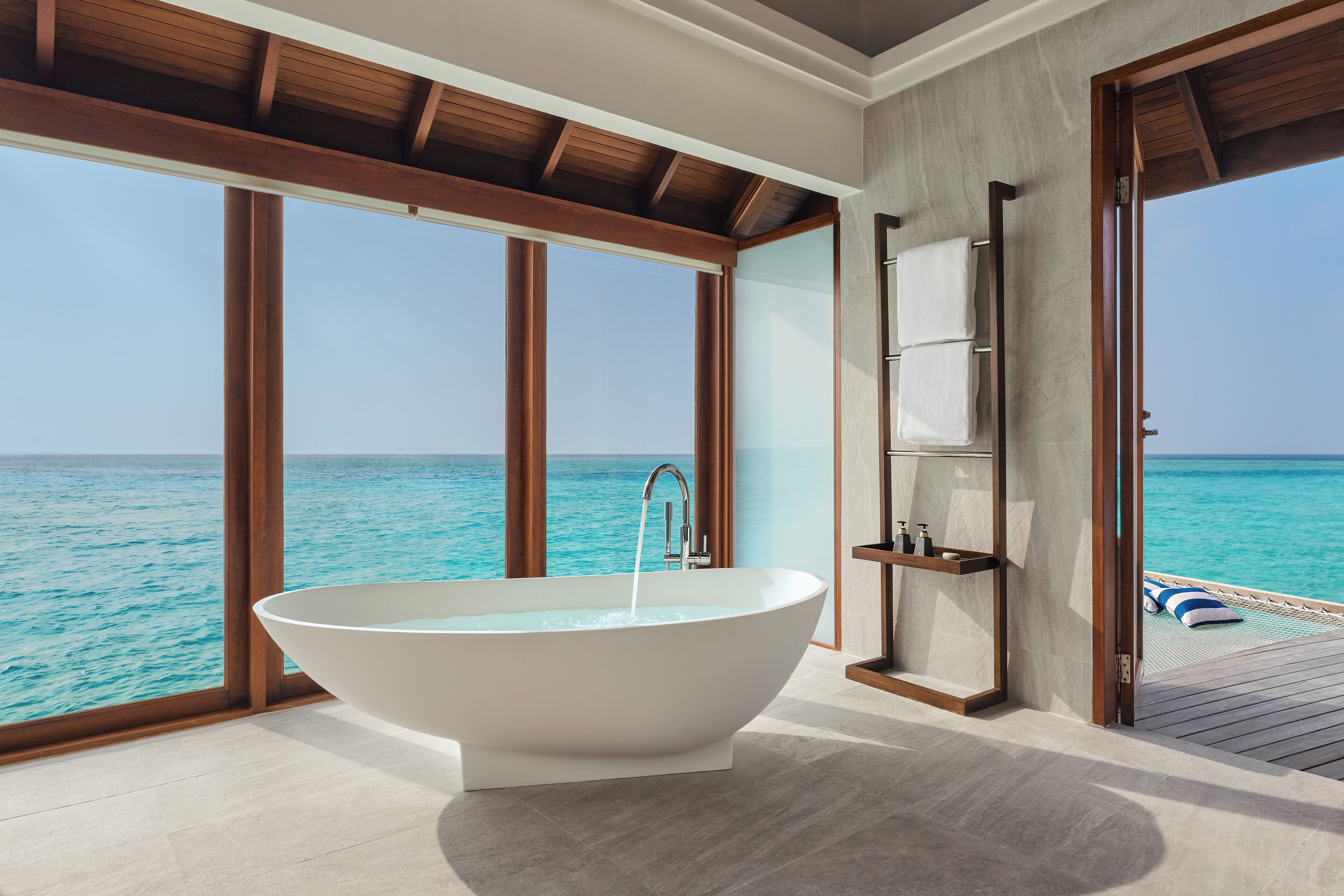 sunset over water villa | bathroom | separate bathtub and shower, deep-soaking bathtub, rainfall showerhead