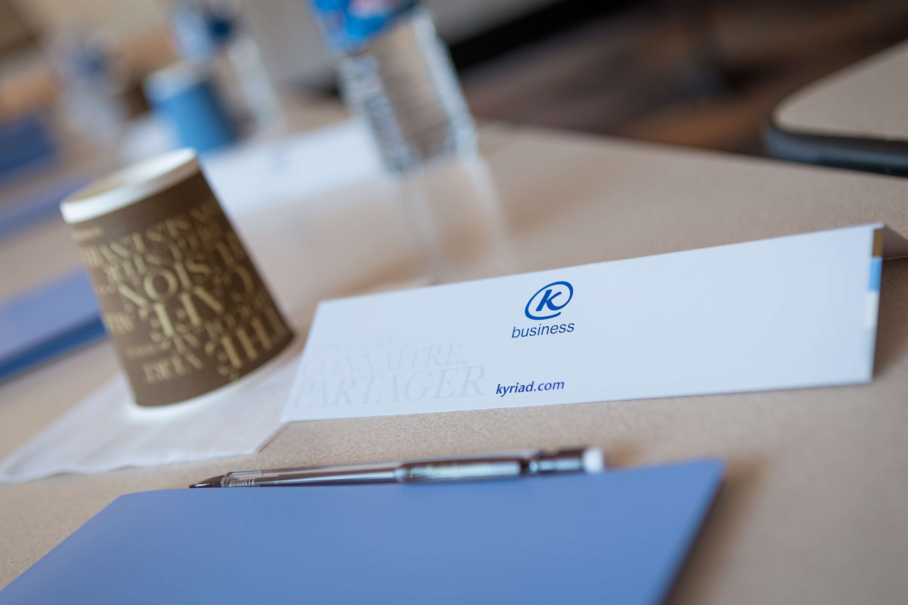 A business card and a pen on a table.
