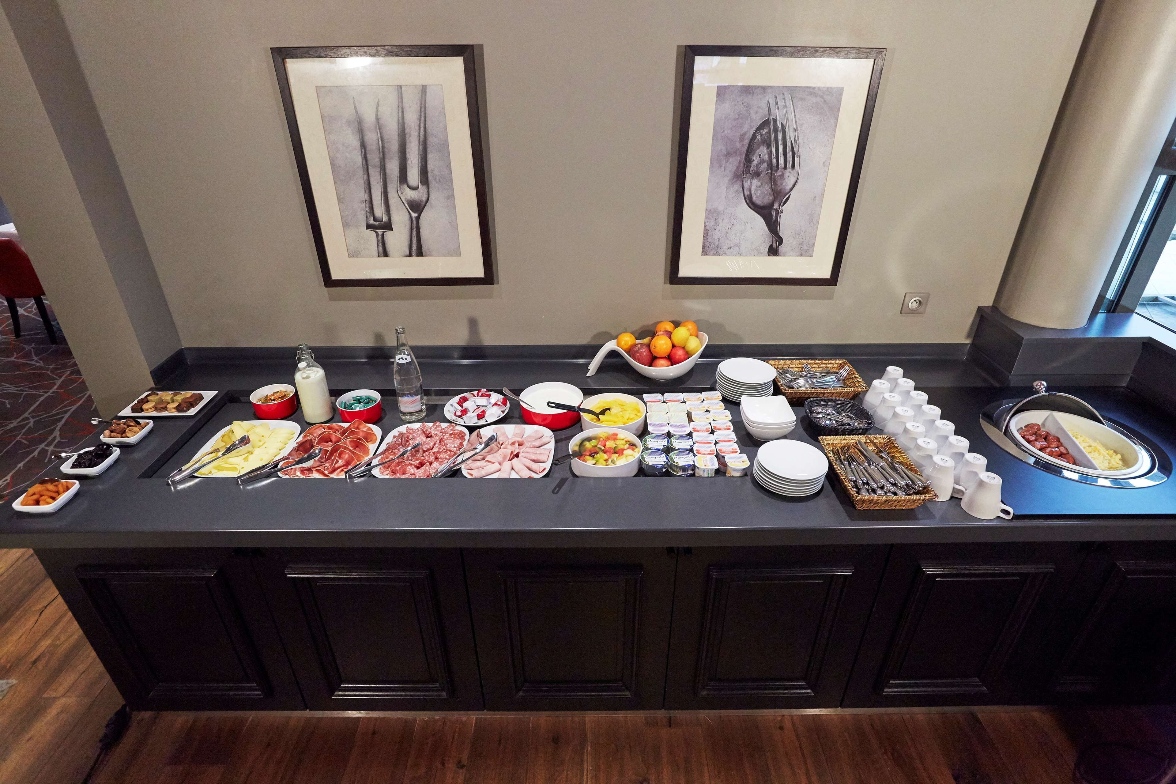 A buffet setup with various food items and utensils.
