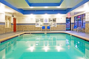 An indoor swimming pool with clear water, blue and beige tiled walls, and a lifeguard station. - Holiday Inn Express & Suites Knoxville-Farragut by IHG (Knoxville)