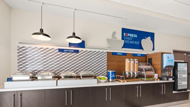 A breakfast station with hot food, cereal, and fruit options, and a sign for Express Start Breakfast. - Holiday Inn Express & Suites Willows by IHG (Willows)