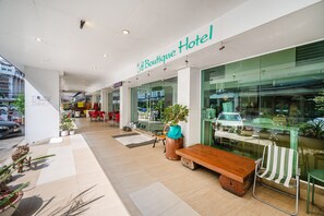 A boutique hotel with a modern interior, featuring a wooden bench and potted plants. - P2 Boutique Hotel (Bangkok)