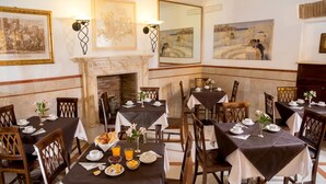 A dining area with multiple tables set for breakfast, featuring bread, eggs, and fruit. - Hotel Luciani (Rome)